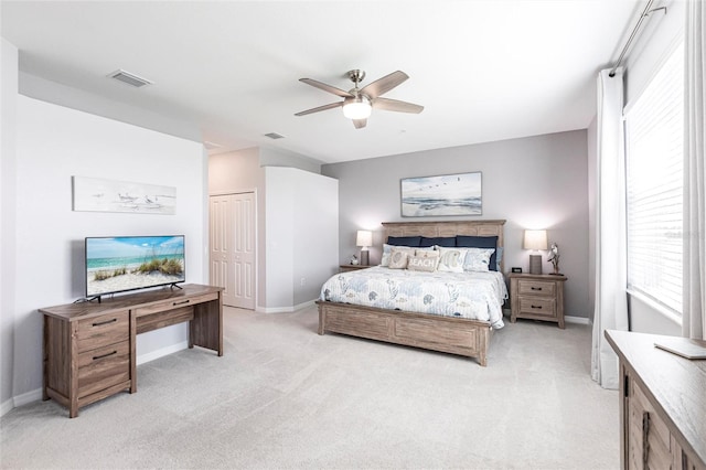 carpeted bedroom with a closet and ceiling fan