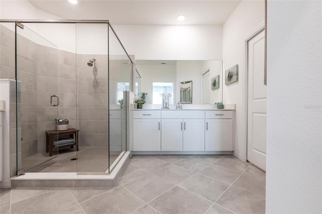 bathroom featuring vanity, tile patterned flooring, and walk in shower