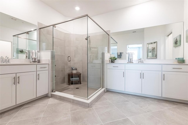 bathroom with tile patterned flooring, vanity, and a shower with door