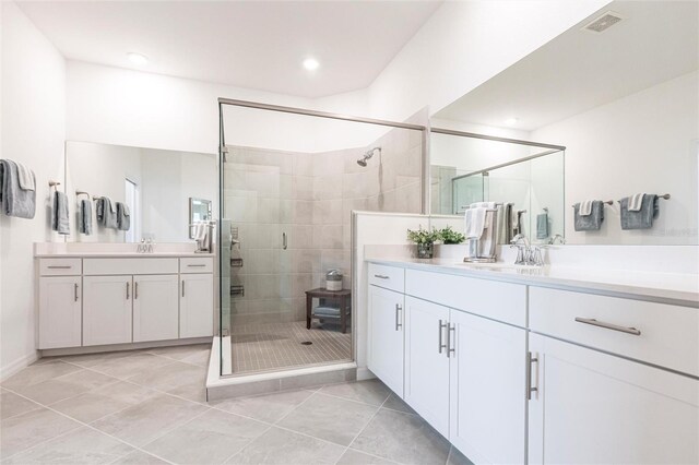 bathroom with vanity, tile patterned flooring, and a shower with door