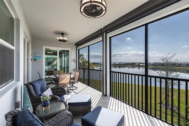 sunroom / solarium with a water view