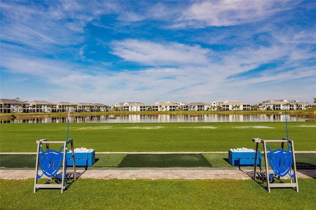 view of community with a lawn and a water view