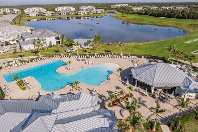 view of pool featuring a water view and a patio area