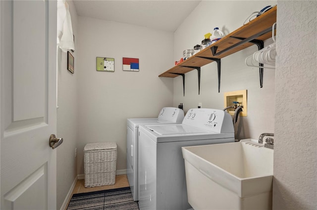 laundry area featuring sink, tile patterned flooring, and washer and dryer