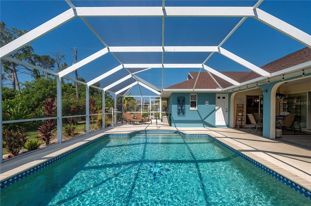 view of pool with a patio and a lanai