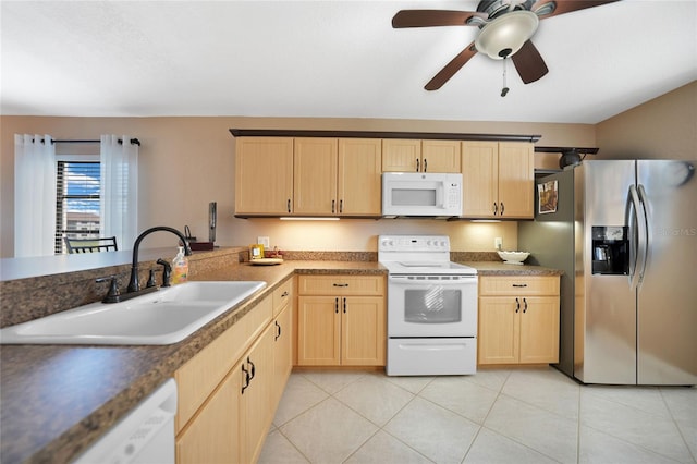 kitchen with sink, white appliances, light tile patterned floors, light brown cabinets, and ceiling fan