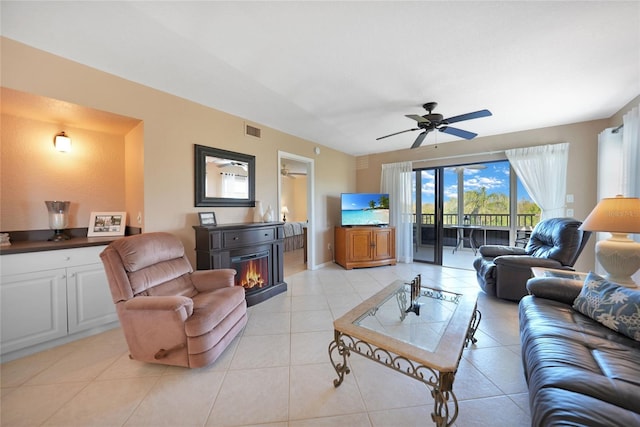 tiled living room featuring ceiling fan