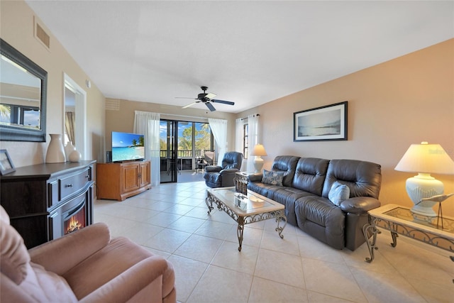 living room with light tile patterned flooring and ceiling fan