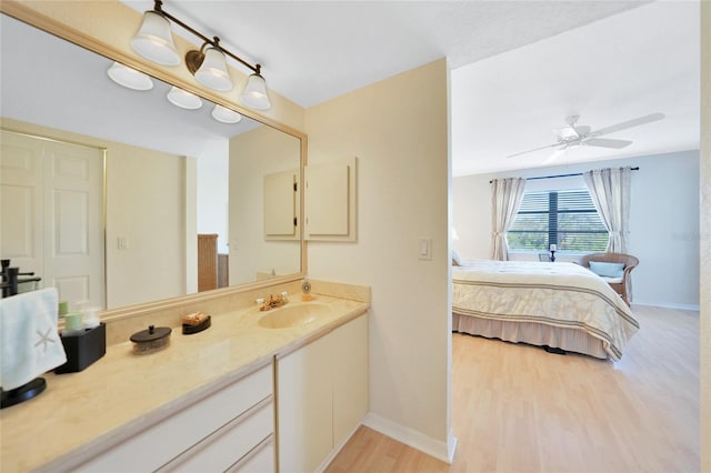 bathroom featuring vanity, hardwood / wood-style floors, and ceiling fan