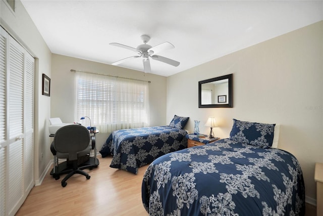 bedroom featuring ceiling fan, hardwood / wood-style floors, and a closet