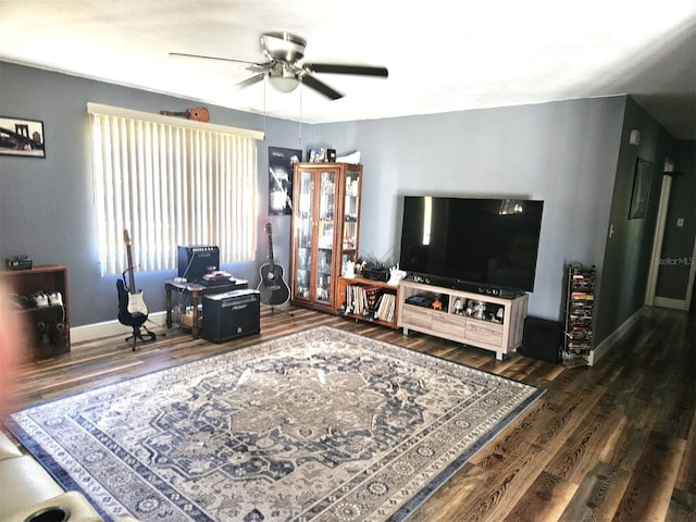 living room with dark wood-type flooring and ceiling fan