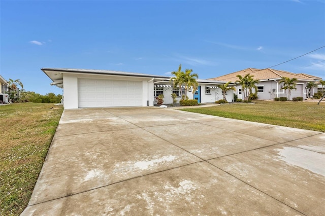 ranch-style house featuring a garage and a front yard