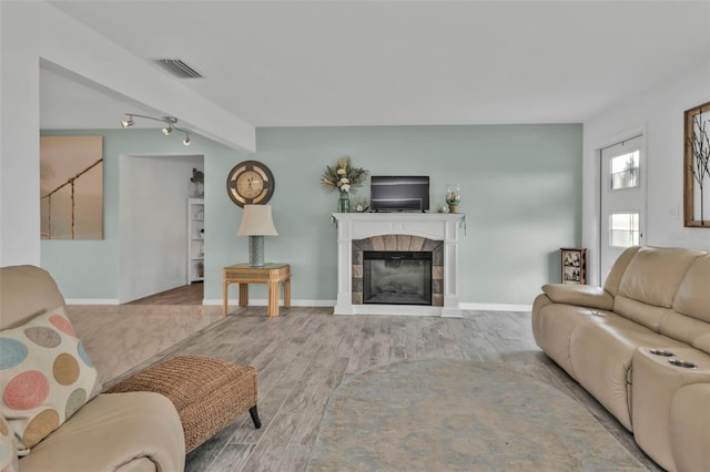 living room with a fireplace and light hardwood / wood-style floors