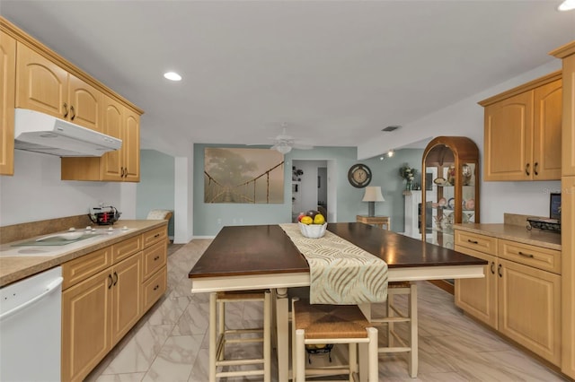 kitchen with ceiling fan, cooktop, dishwasher, and light brown cabinets