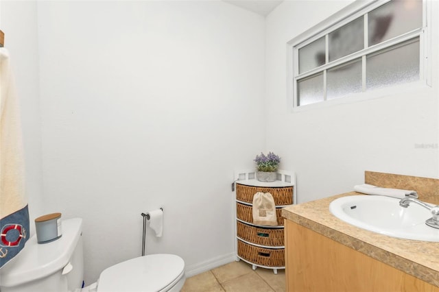 bathroom featuring tile patterned flooring, vanity, and toilet