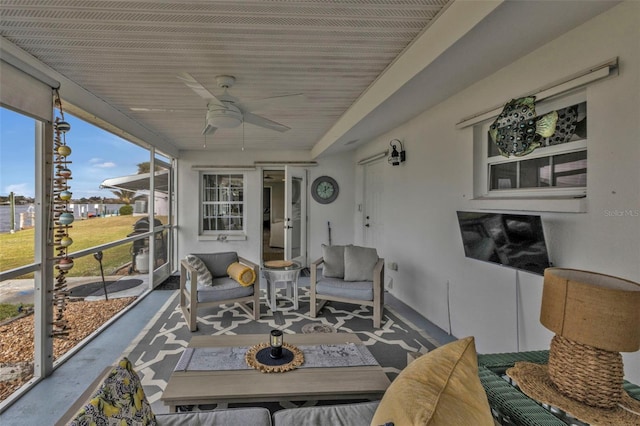 sunroom with ceiling fan and wooden ceiling