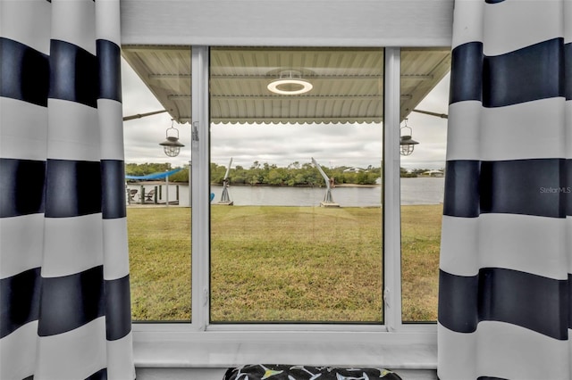 doorway featuring a healthy amount of sunlight and a water view