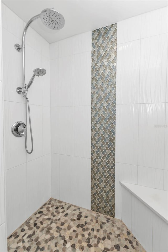 bathroom with a tile shower