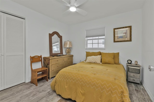 bedroom with hardwood / wood-style floors, a closet, and ceiling fan