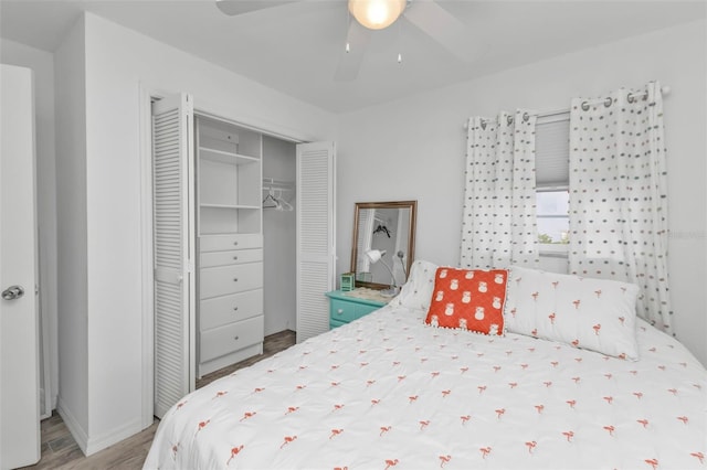 bedroom with hardwood / wood-style floors, a closet, and ceiling fan