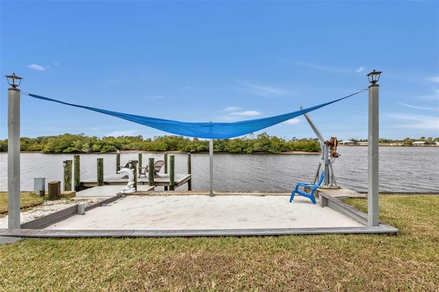 view of dock featuring a water view and a yard