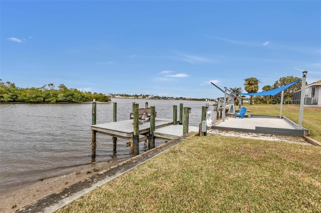 dock area with a water view and a yard