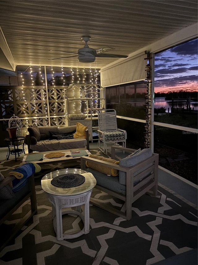 exterior space featuring ceiling fan and an outdoor living space with a fire pit