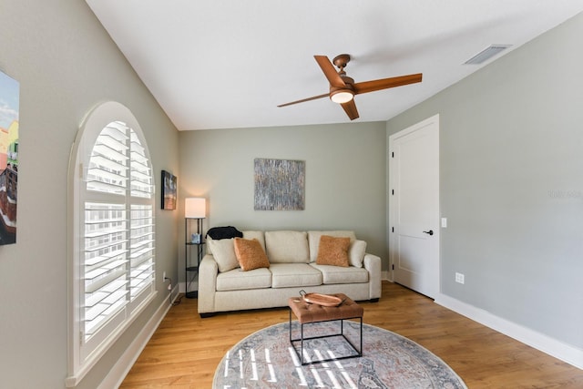 living room featuring ceiling fan and light wood-type flooring