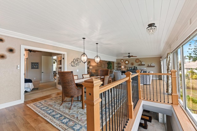 interior space featuring ceiling fan, ornamental molding, wood-type flooring, and wooden ceiling