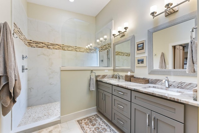 bathroom with tile patterned floors, vanity, and a tile shower