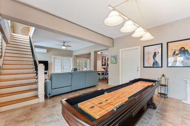 game room featuring a wall unit AC, french doors, and ceiling fan