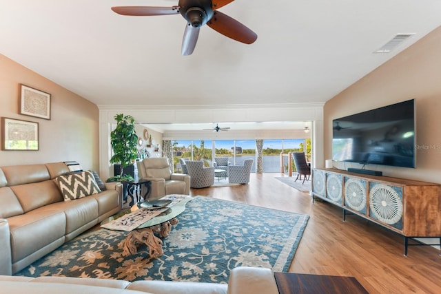 living room featuring vaulted ceiling, ceiling fan, and light hardwood / wood-style floors