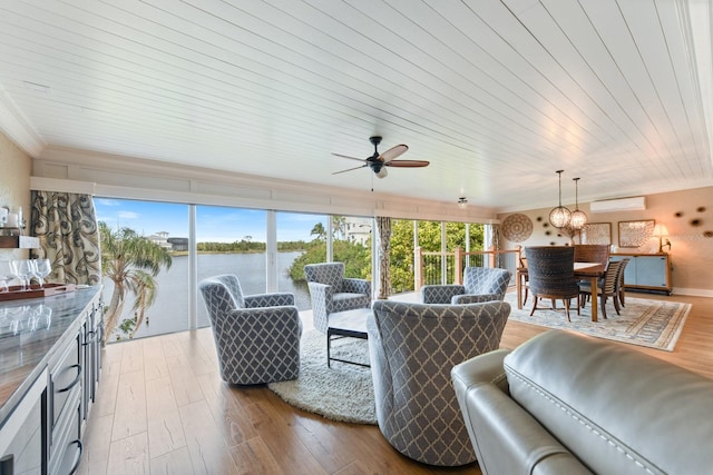 living room with a water view, ornamental molding, and light hardwood / wood-style flooring