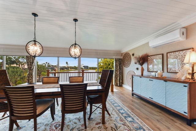 dining area featuring a notable chandelier, crown molding, light hardwood / wood-style flooring, and a wall unit AC