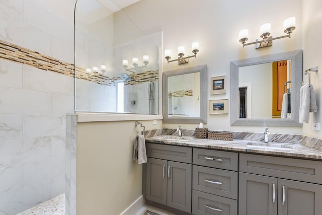 bathroom with vanity and a tile shower