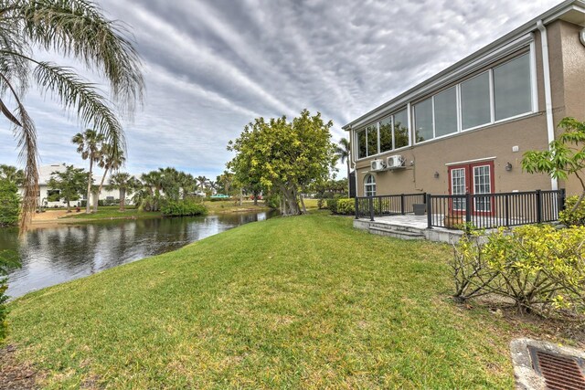 view of yard with a water view and french doors