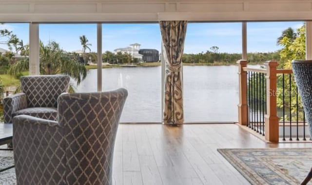 sunroom / solarium featuring a water view