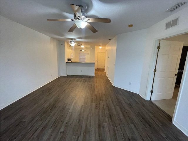 unfurnished living room featuring ceiling fan and dark wood-type flooring