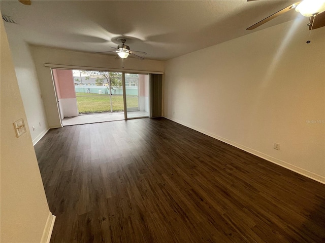 empty room featuring ceiling fan and dark hardwood / wood-style floors