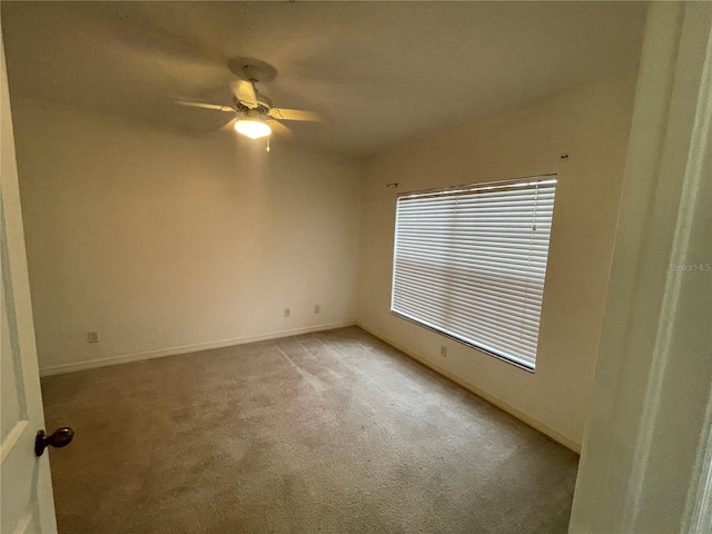 unfurnished room featuring ceiling fan and light colored carpet