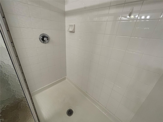 bathroom with tiled shower