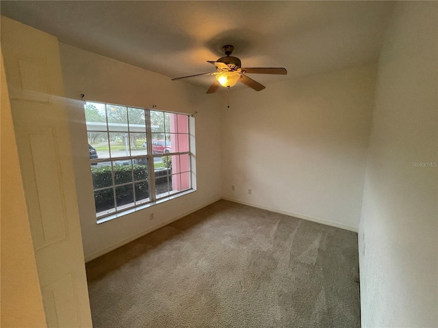 carpeted empty room with ceiling fan