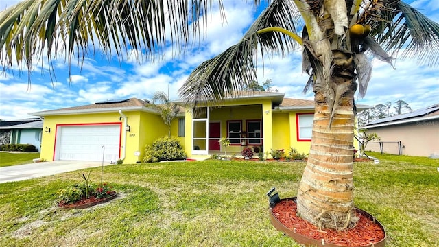 view of front of property with a garage and a front lawn