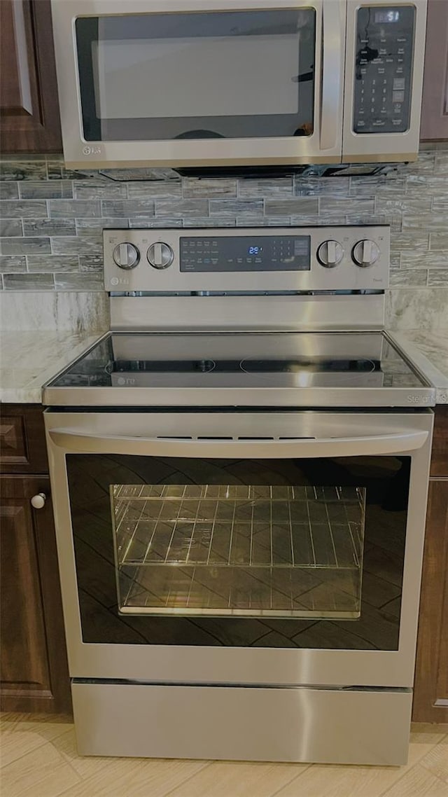 room details featuring stainless steel appliances and dark brown cabinetry