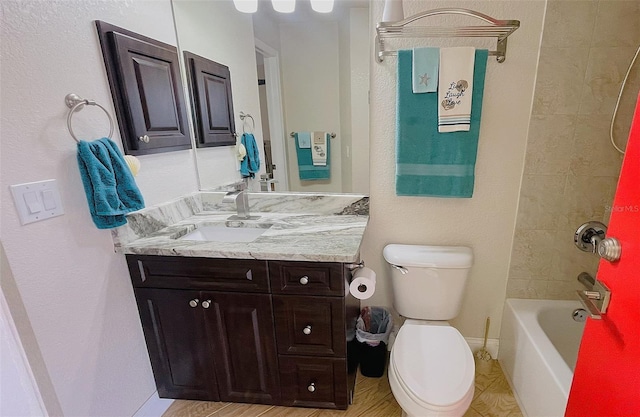 full bathroom with vanity, toilet, and tiled shower / bath