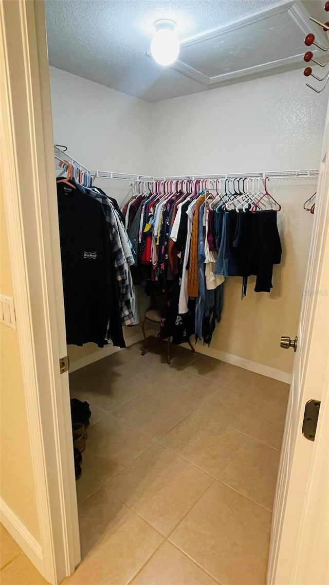 spacious closet featuring light tile patterned flooring