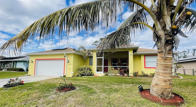 view of front of property featuring a garage and a front lawn