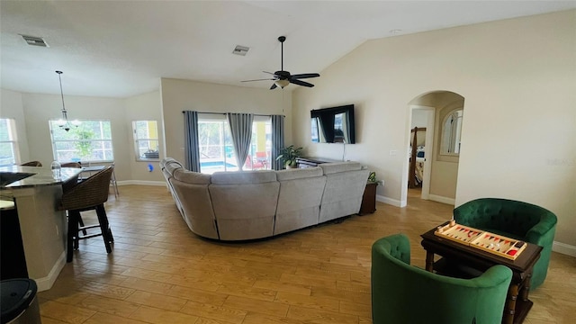 living room featuring lofted ceiling, light hardwood / wood-style flooring, and ceiling fan