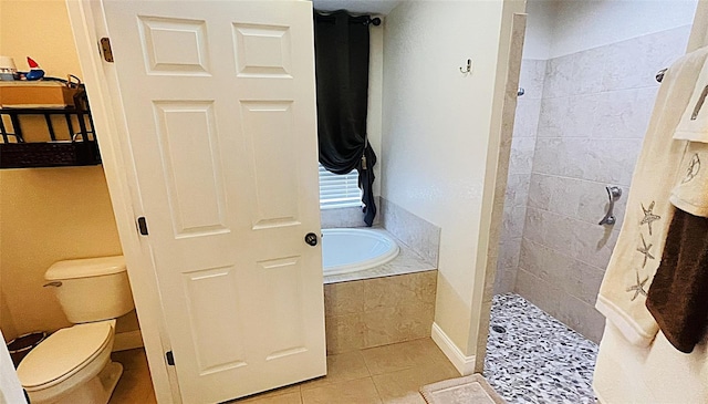 bathroom featuring tile patterned flooring, toilet, and separate shower and tub