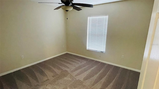 empty room featuring ceiling fan and carpet